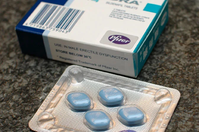 A Viagra carton beside a blister of blue diamond-shaped tablets